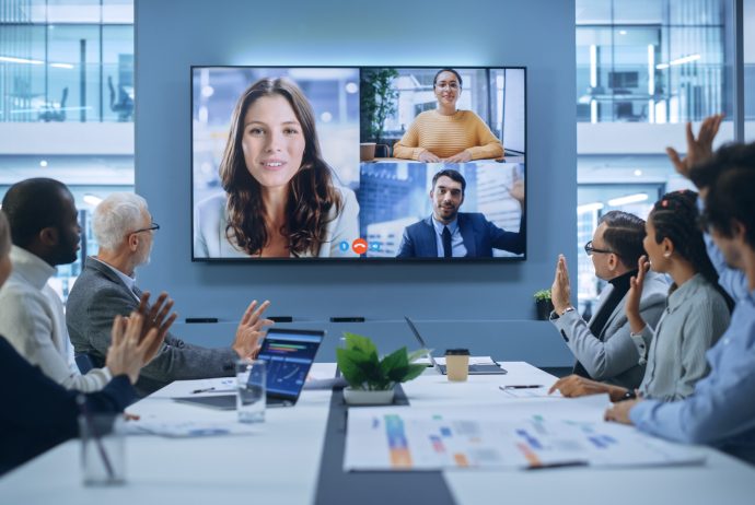 Video Conference Call in Office Boardroom Meeting Room: Executive Directors Talk with Group of Multi-Ethnic Entrepreneurs, Managers, Investors. Businesspeople Discuss e-Commerce Investment Strategy