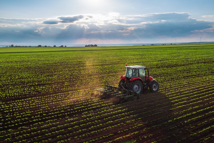 Tractor cultivating field at spring,aerial view